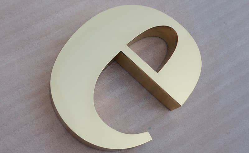 Polished brass signs
