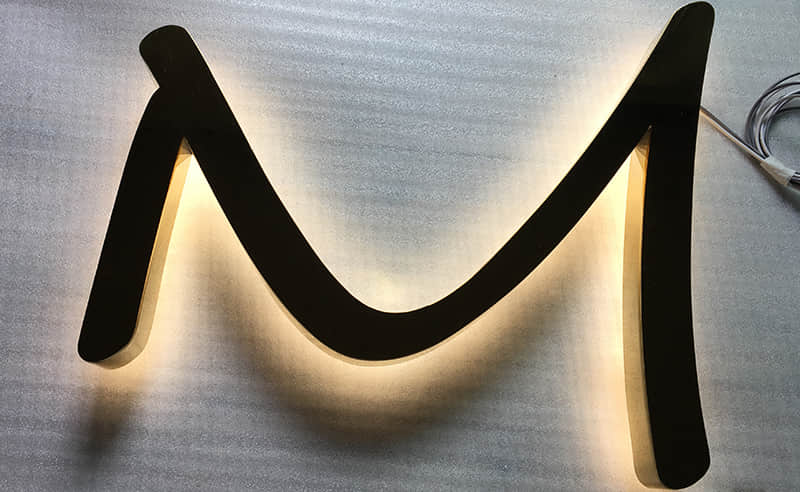 Backlit brass letters