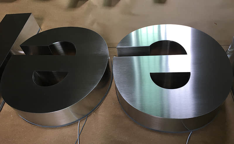 Backlit stainless steel signs