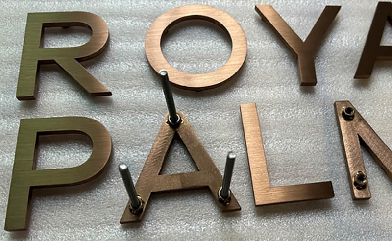 Electroplated solid stainless steel signage